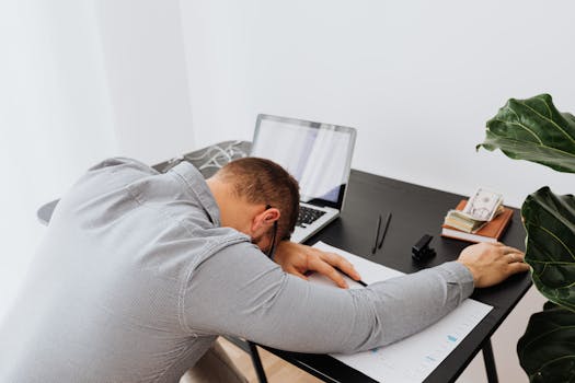 a tired professional sitting at a desk