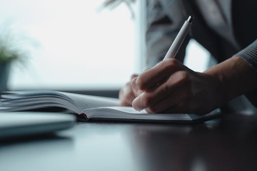 person writing in a journal