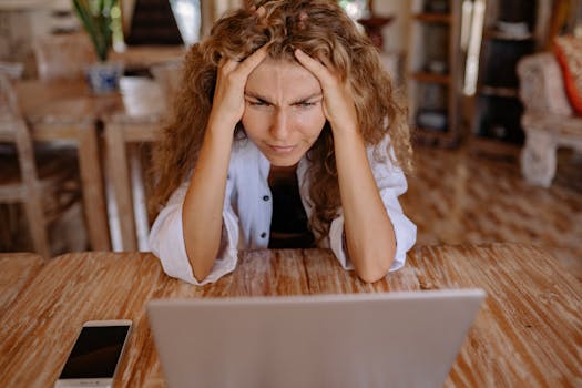 Image of a stressed professional working late